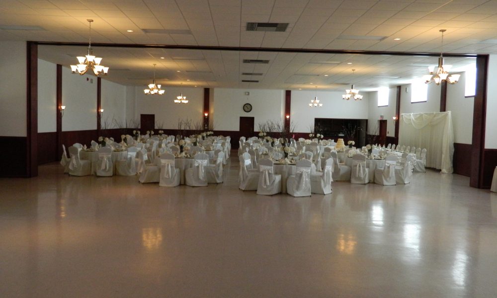 White tables and chairs for a wedding